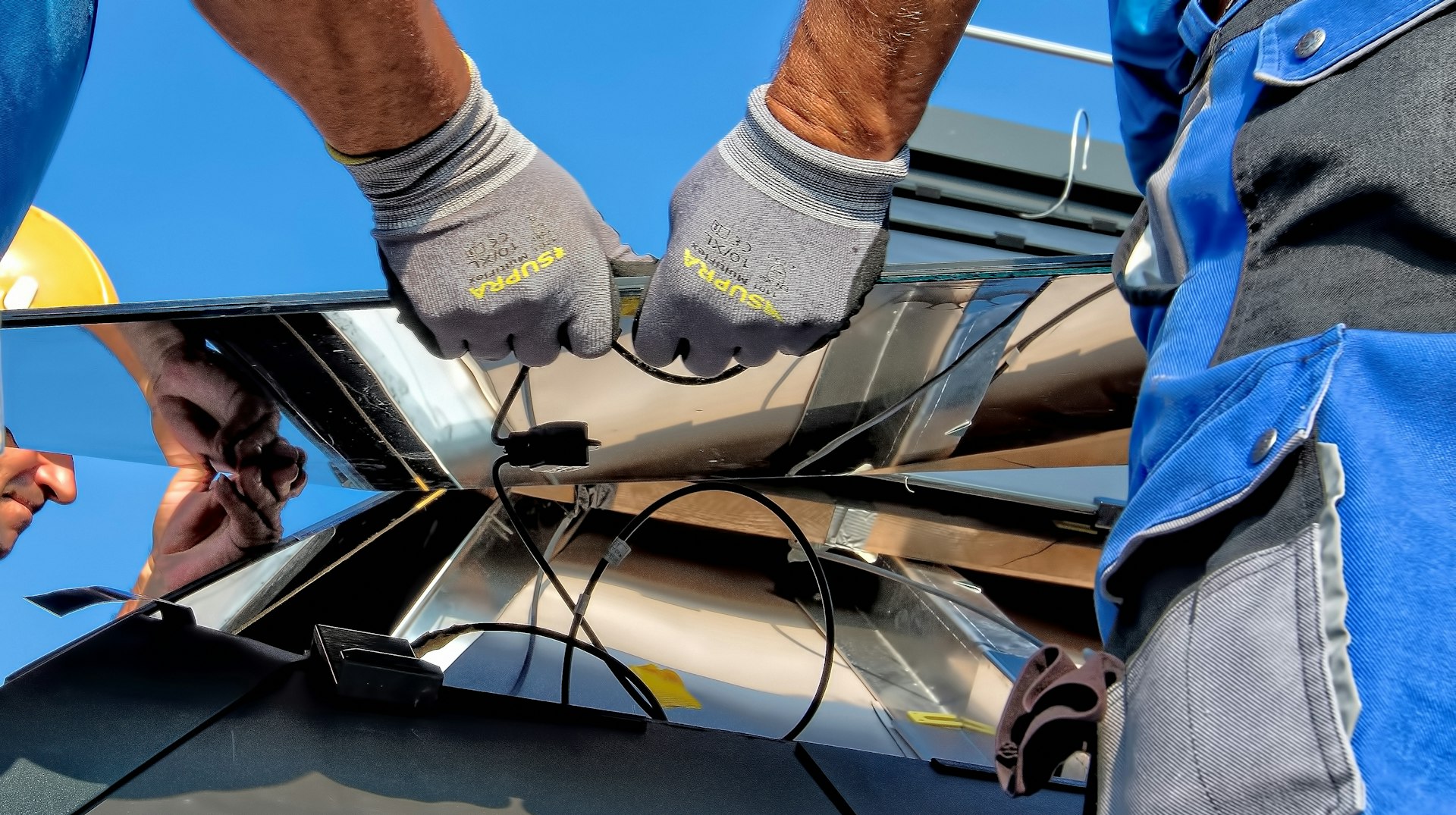 Renewable Energy Generation Systems two men carrying a metal sheet